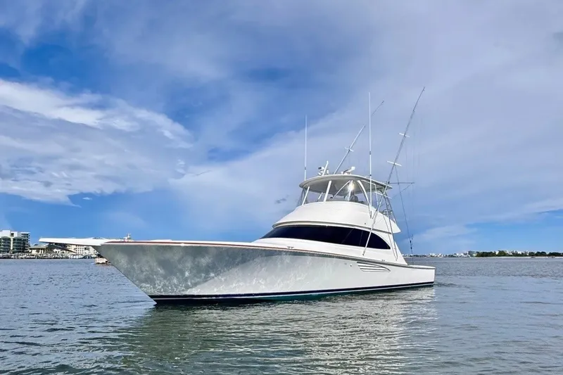 The Image of 2018 Viking 52 Convertible yacht on calm water under a blue sky. - 0