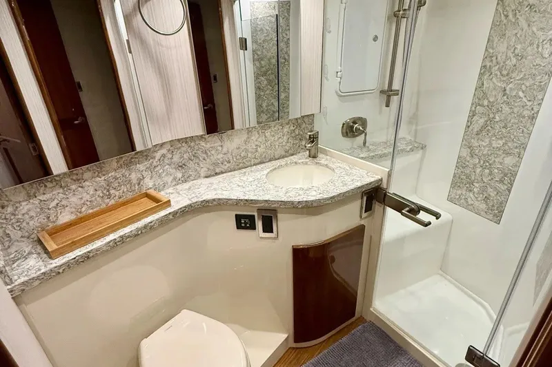 Slide: The Image of Luxurious bathroom in 2018 Viking 52 Convertible yacht with marble countertop and modern shower. - 17