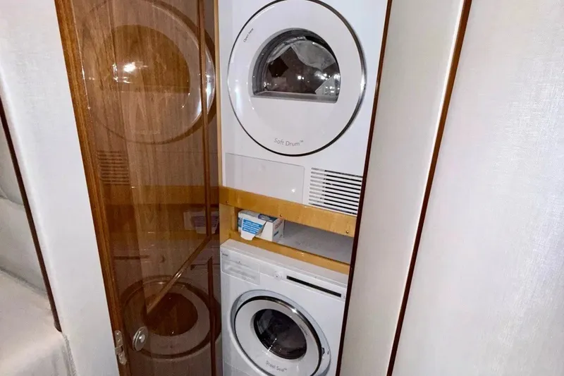 Slide: The Image of Stacked washer and dryer in 2018 Viking 52 Convertible yacht laundry area. - 19