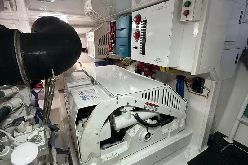 Slide: The Image of Engine room of a 2018 Viking 52 Convertible yacht, showcasing machinery and control panels. - 26