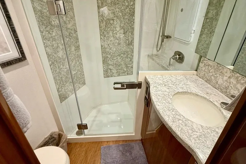 Slide: The Image of Luxurious bathroom in 2018 Viking 52 Convertible yacht with marble accents and modern fixtures. - 16
