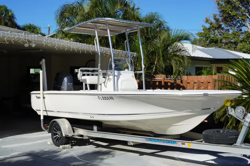 The Image of 2016 Tidewater 1910 Bay Max boat on trailer, parked in driveway with palm trees. - 0
