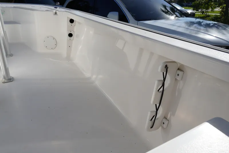 Slide: The Image of 2016 Tidewater 1910 Bay Max boat interior with clean white deck and storage features. - 14