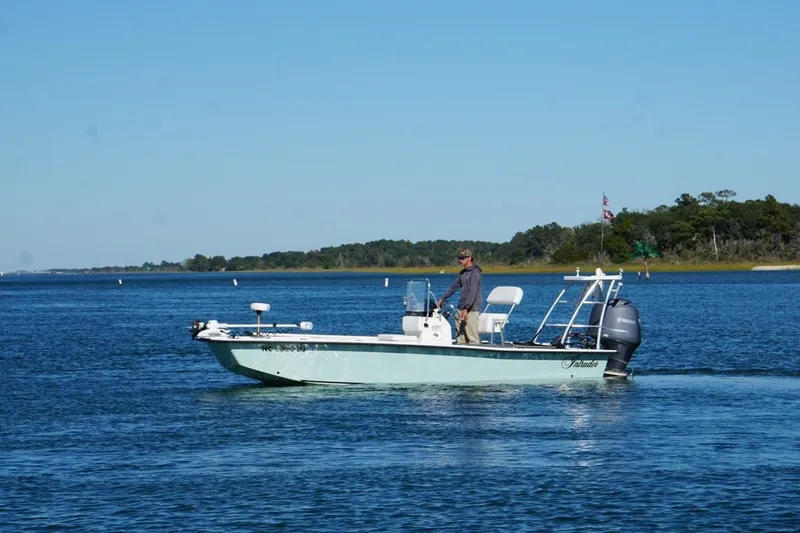 Slide: The Image of 2008 Intruder 198 boat cruising on a calm lake with a person steering. - 7