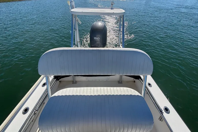 Slide: The Image of 2008 Intruder 198 boat with white seating and 150 HP motor on water. - 15