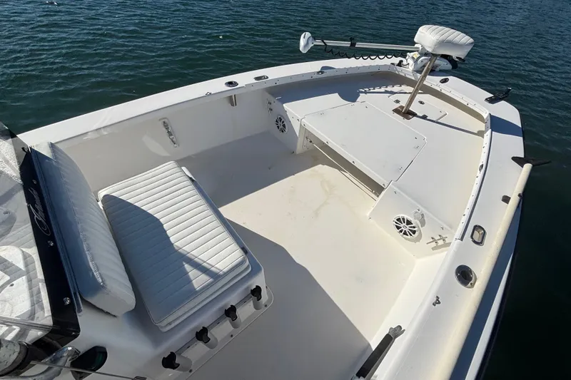 Slide: The Image of 2008 Intruder 198 boat interior with seating and fishing equipment on calm water. - 11