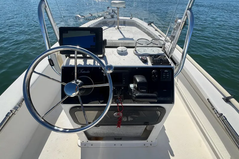 Slide: The Image of 2008 Intruder 198 boat console with steering wheel and navigation equipment on water. - 9