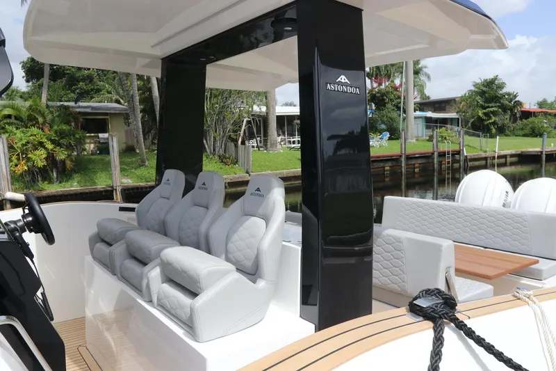 Slide: The Image of 2024 Astondoa 377 Coupe Outboard luxury seating area with modern design and waterfront view. - 24