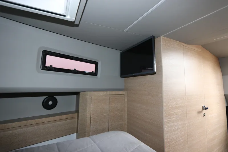 Slide: The Image of 2024 Astondoa 377 Coupe Outboard cabin interior with modern design and window view. - 39