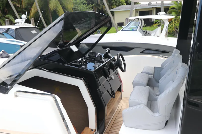 Slide: The Image of 2024 Astondoa 377 Coupe Outboard cockpit with modern controls and comfortable seating. - 21