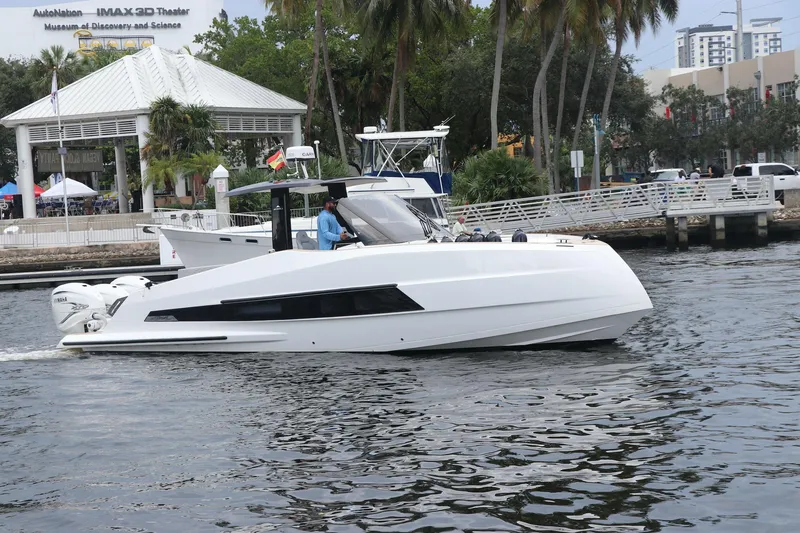 Slide: The Image of 2024 Astondoa 377 Coupe Outboard cruising on a scenic waterfront. - 4