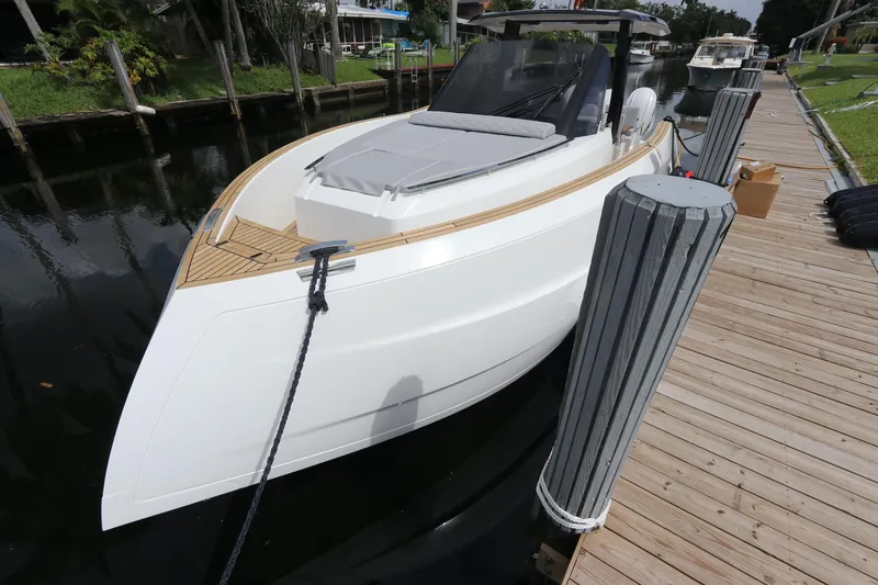 Slide: The Image of 2024 Astondoa 377 Coupe Outboard docked, sleek white design, modern luxury boat. - 9