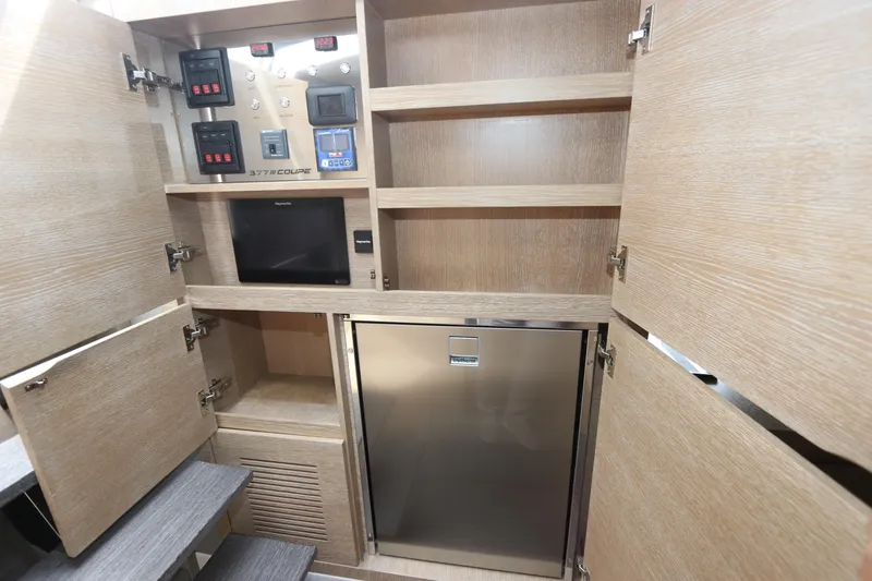 Slide: The Image of 2024 Astondoa 377 Coupe Outboard interior with control panels and storage cabinets. - 36
