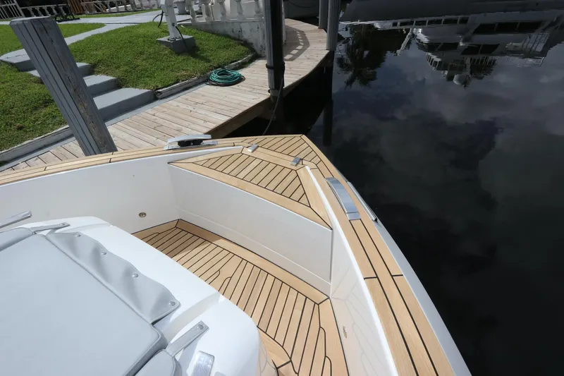 Slide: The Image of 2024 Astondoa 377 Coupe Outboard boat with sleek deck design by the water. - 11