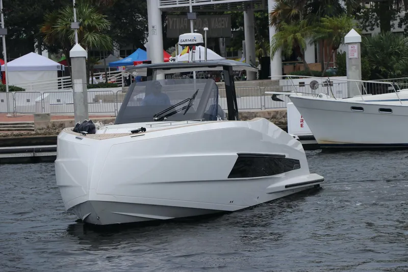 Slide: The Image of 2024 Astondoa 377 Coupe Outboard boat on water, sleek design, modern marina backdrop. - 2