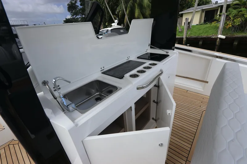 Slide: The Image of 2024 Astondoa 377 Coupe Outboard yacht kitchen with sink and stove. - 26