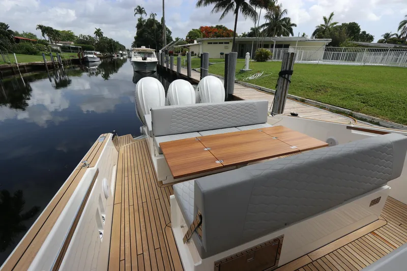 Slide: The Image of 2024 Astondoa 377 Coupe Outboard, luxury yacht docked by a serene canal. - 30