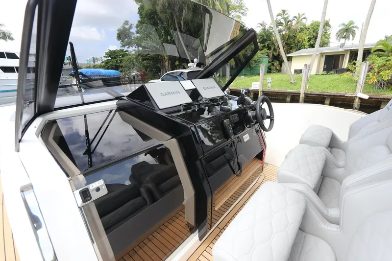 Slide: The Image of 2024 Astondoa 377 Coupe Outboard helm with modern controls and luxurious seating. - 20