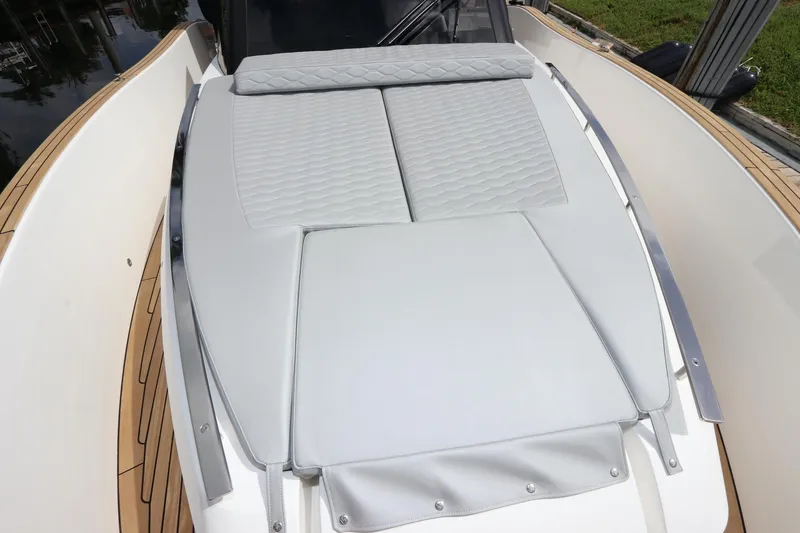 Slide: The Image of 2024 Astondoa 377 Coupe Outboard boat with sleek deck design and cushioned seating. - 16