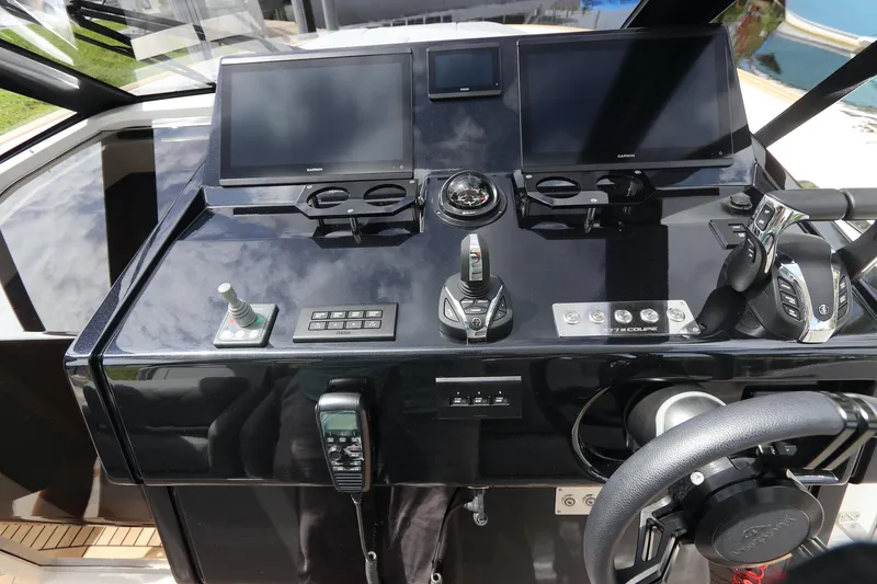 Slide: The Image of 2024 Astondoa 377 Coupe Outboard helm with modern navigation displays and controls. - 23