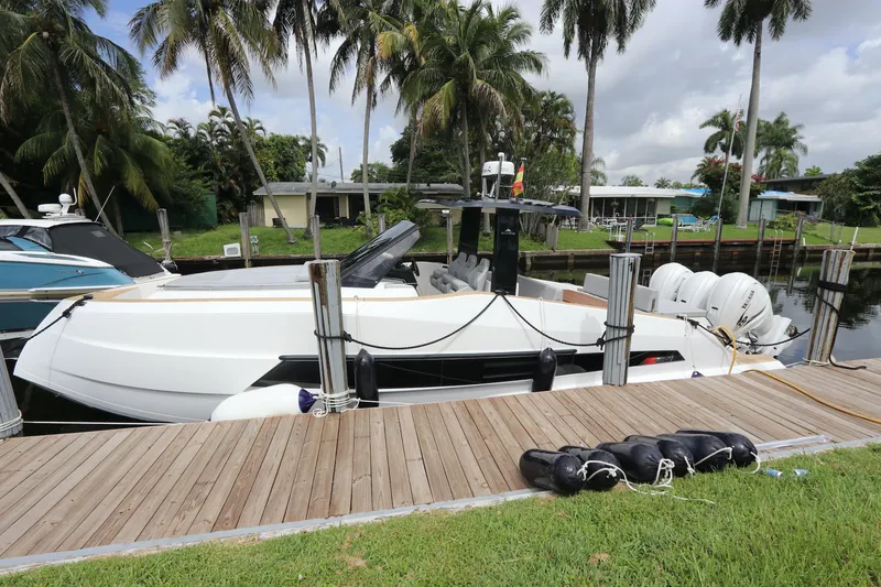 Slide: The Image of 2024 Astondoa 377 Coupe Outboard docked by palm trees. - 8