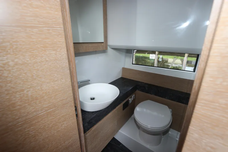 Slide: The Image of 2024 Astondoa 377 Coupe Outboard bathroom with modern sink and toilet. - 40