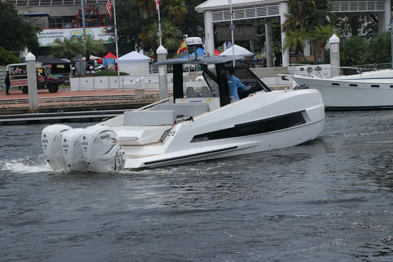 Slide: The Image of 2024 Astondoa 377 Coupe Outboard cruising on a waterfront with modern design. - 5