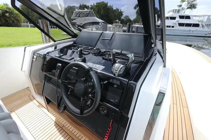 Slide: The Image of 2024 Astondoa 377 Coupe Outboard helm with modern controls and sleek design. - 22