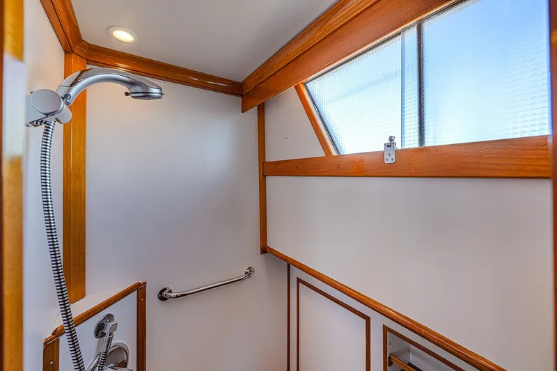 Slide: The Image of Shower area in 2002 Grand Banks 46 Classic yacht with wooden trim and window. - 8