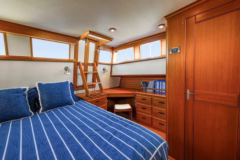 Slide: The Image of Luxurious cabin interior of 2002 Grand Banks 46 Classic yacht with striped bedding. - 12