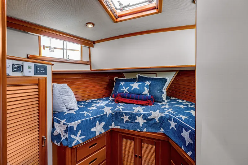 Slide: The Image of Cozy cabin interior of 2002 Grand Banks 46 Classic yacht with starfish-themed bedding. - 17