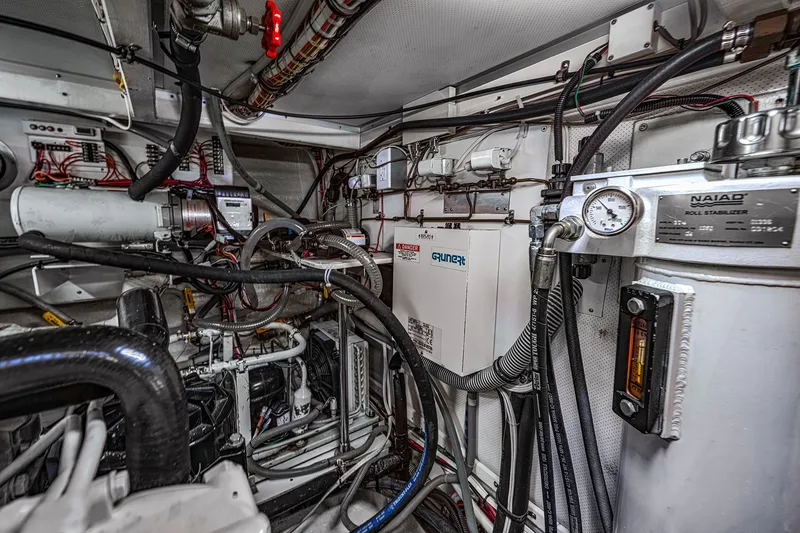 Slide: The Image of Engine room of 2002 Grand Banks 46 Classic yacht, featuring complex machinery and wiring. - 33