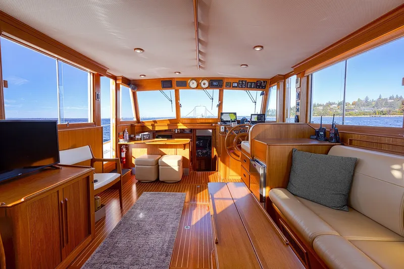 Slide: The Image of Interior of 2002 Grand Banks 46 Classic yacht with wooden furnishings and panoramic windows. - 21