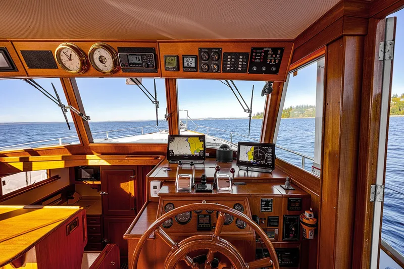 Slide: The Image of Grand Banks 46 Classic 2002 yacht helm with wooden finish and navigation equipment. - 20