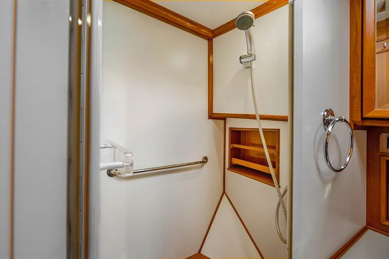 Slide: The Image of Shower area in 2002 Grand Banks 46 Classic yacht with wooden accents and modern fixtures. - 16