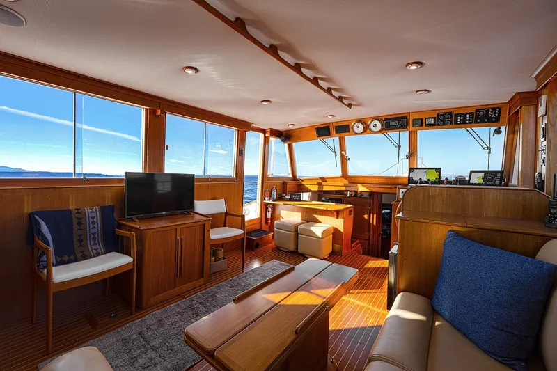 Slide: The Image of Luxurious interior of 2002 Grand Banks 46 Classic yacht with panoramic windows and elegant wood finish. - 22