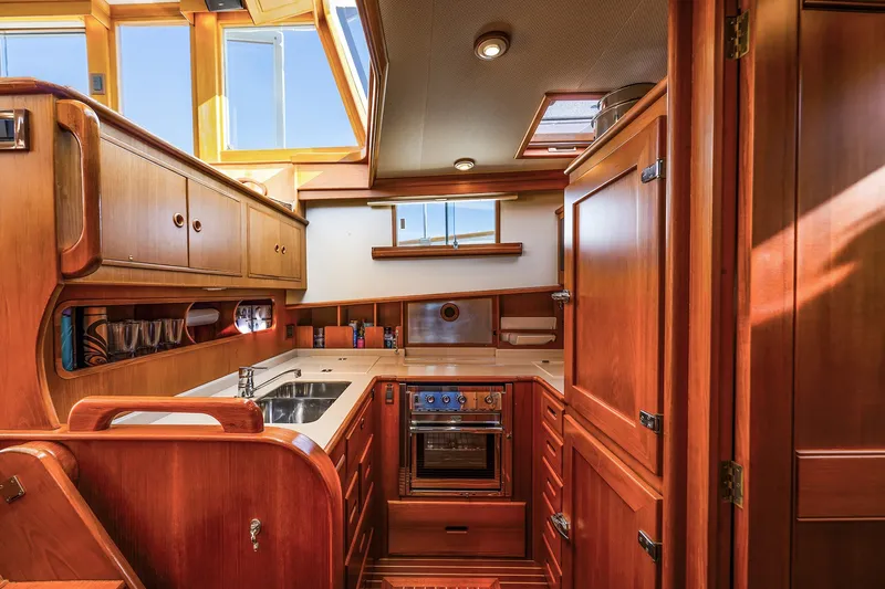 Slide: The Image of Luxurious wooden interior of 2002 Grand Banks 46 Classic yacht kitchen. - 13