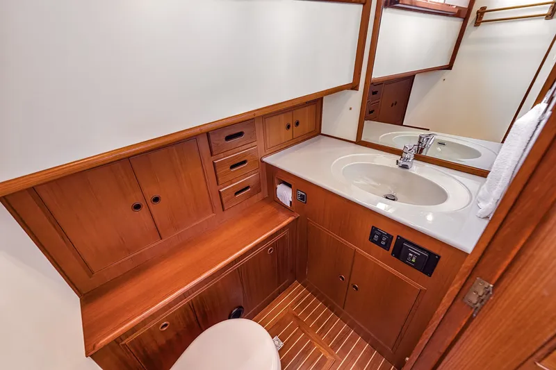 Slide: The Image of Luxurious wooden bathroom interior on a 2002 Grand Banks 46 Classic yacht. - 10