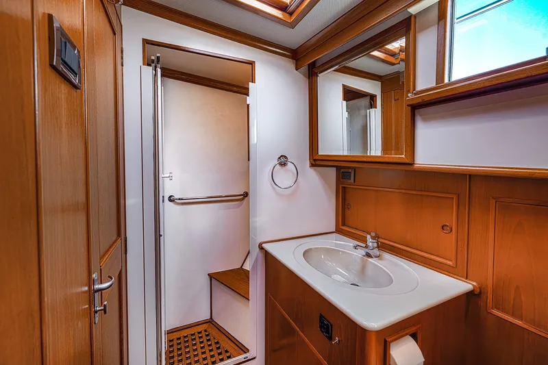 Slide: The Image of Luxurious bathroom interior of 2002 Grand Banks 46 Classic yacht with wooden accents. - 14