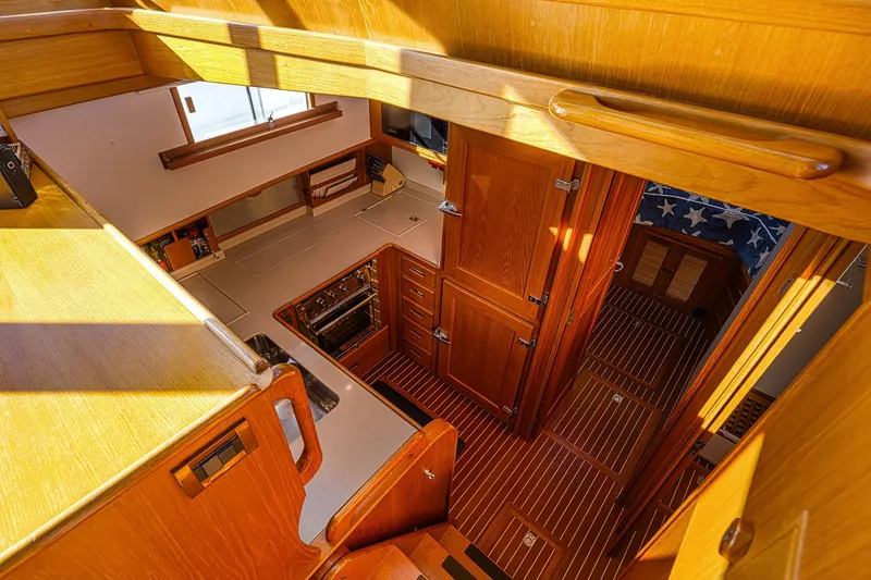 Slide: The Image of Interior of 2002 Grand Banks 46 Classic yacht, featuring wooden cabinetry and flooring. - 24