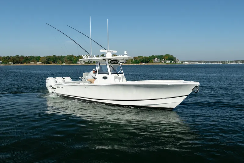 Slide: The Image of A white motorboat cruises on calm water, featuring two fishing rods and a clear blue sky. - 9