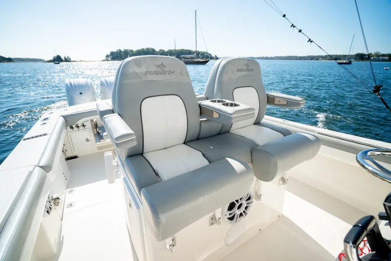 Slide: The Image of Two luxurious seats on a boat overlooking the water with other boats in the background. - 24