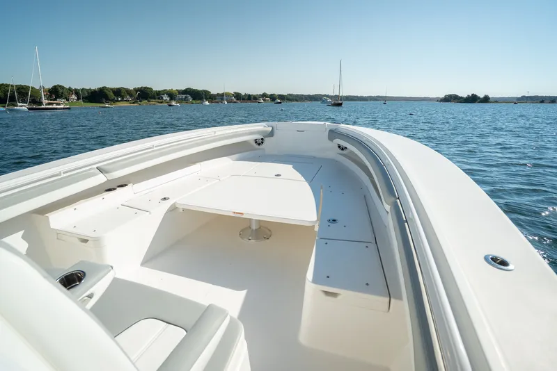 Slide: The Image of Regulator 34 CC 2022: Spacious bow area with seating, anchored on calm water. - 15