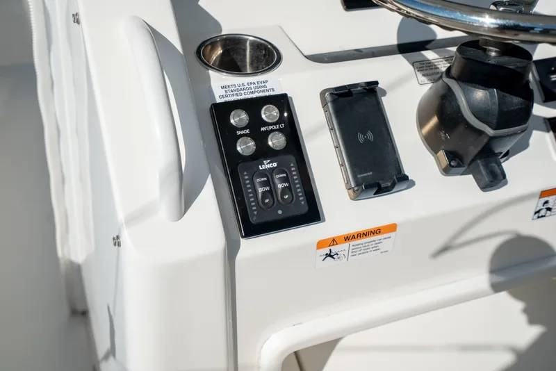 Slide: The Image of Close-up of a Regulator 34 CC boat's helm with controls and warning labels. - 28