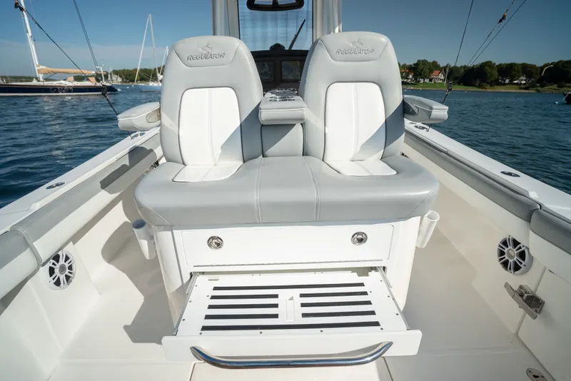 Slide: The Image of The image shows the cockpit of a 2022 Regulator 34 CC boat with two cushioned seats. - 31