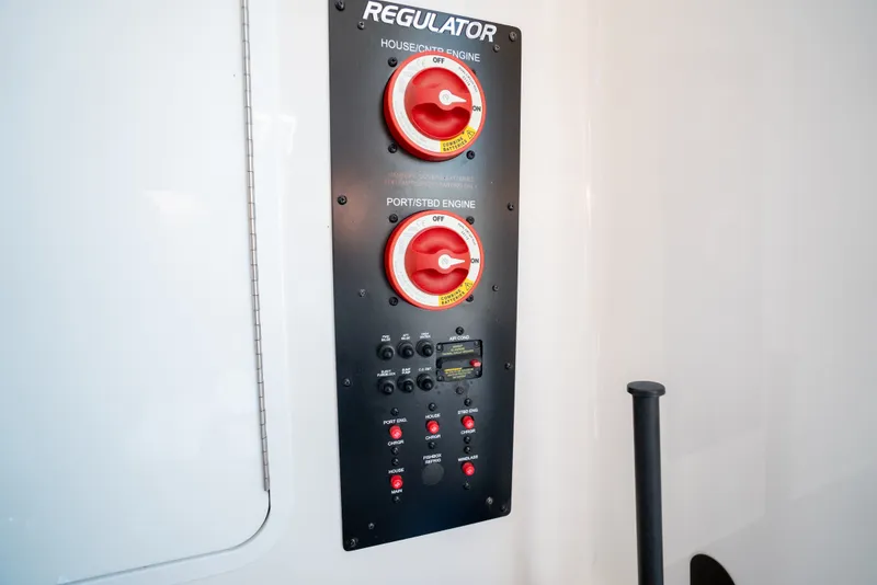 Slide: The Image of Control panel with red switches and Regulator logo. - 38
