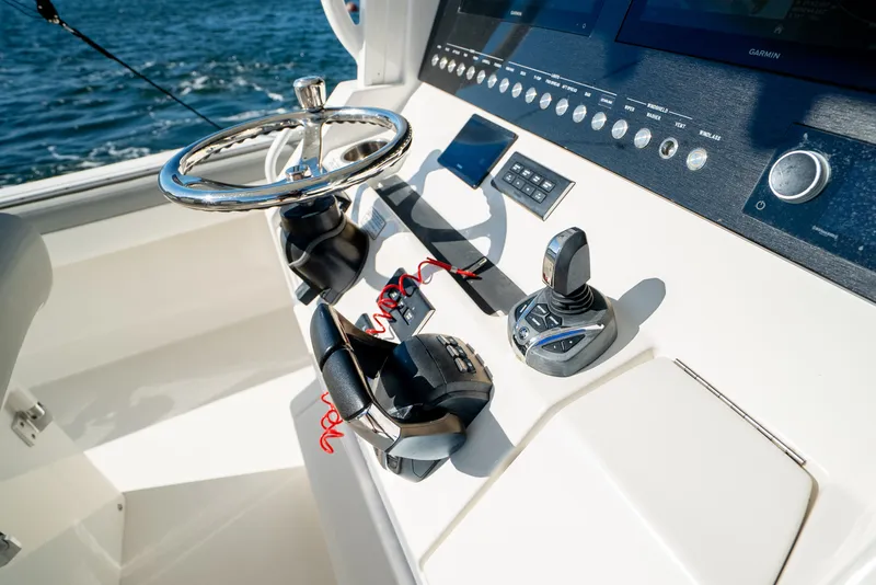 Slide: The Image of The cockpit of a 2022 Regulator 34 CC with modern steering and electronics. - 25