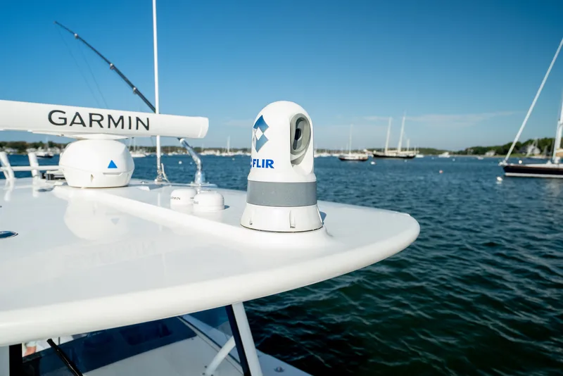 Slide: The Image of Close-up of a boat roof with Garmin and FLIR equipment, calm harbor in the background. - 19
