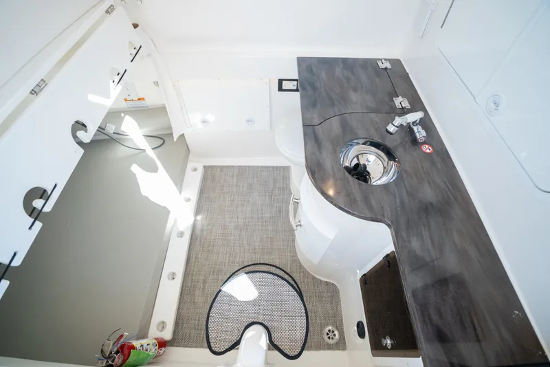 Slide: The Image of Interior of a 2022 Regulator 34 CC with sink and storage area. - 34
