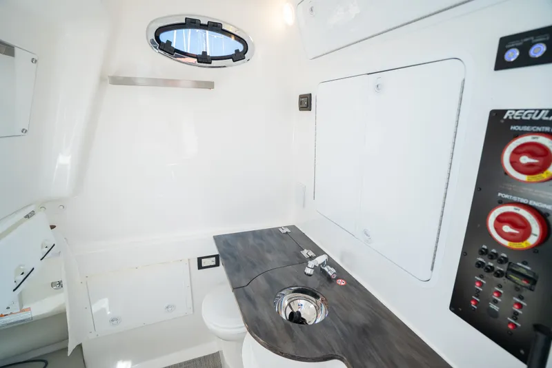 Slide: The Image of Interior of a 2022 Regulator 34 CC with sink, control panel, and porthole. - 35